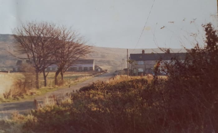 A long view past the stable building (left) and houses (right) to New Bank past Low Drum, where wagons from three directions were lowered to the Tip Yard (behind the photographer).