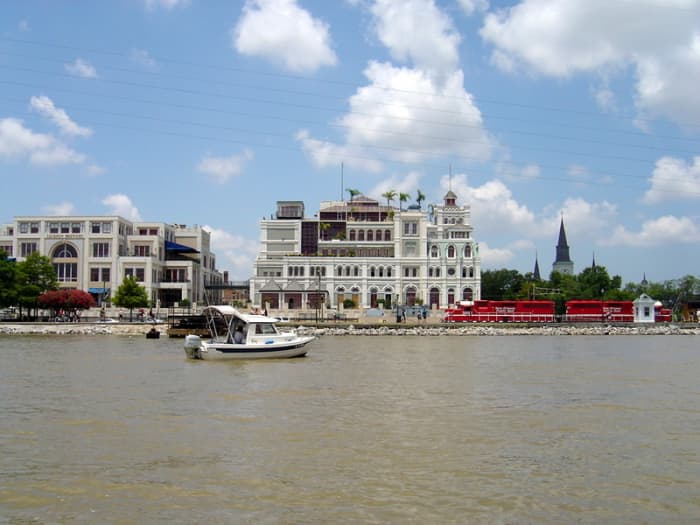 The C-Dory "See-Saw" near the French Quarter of New Orleans, with Jax Brewery (now a shopping center), St. Louis Cathedral, and the red New Orleans Public Belt train, providing transport among local industries.