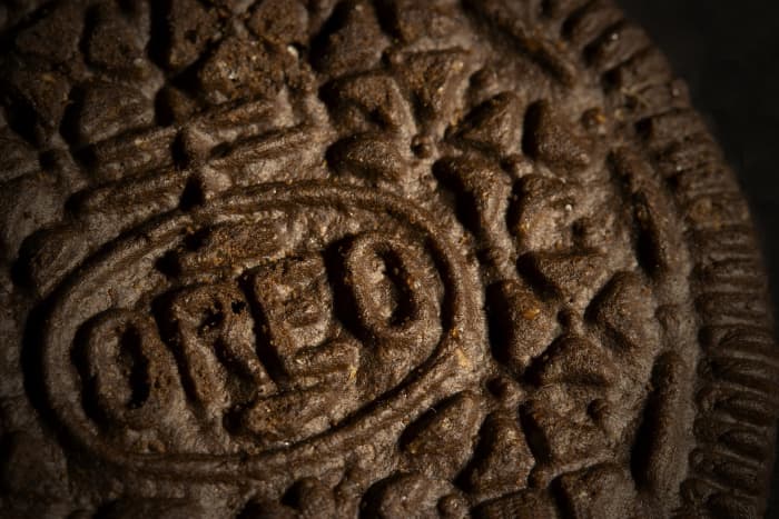 The Oreo design features the word "Oreo" surrounded by an oval with a double-crossed line, which also happens to be Nabisco's logo and surrounding that are four-petaled flower shapes.