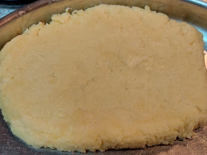 Transfer the dough onto the greased plate or tray. Set well, forming a single block using a knife or any flat surface.