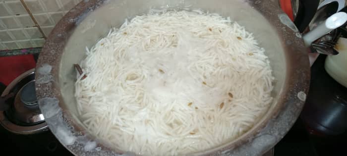 Let the water boil. Then add the soaked rice. When all the rice starts to come up, check it with help of a spoon.