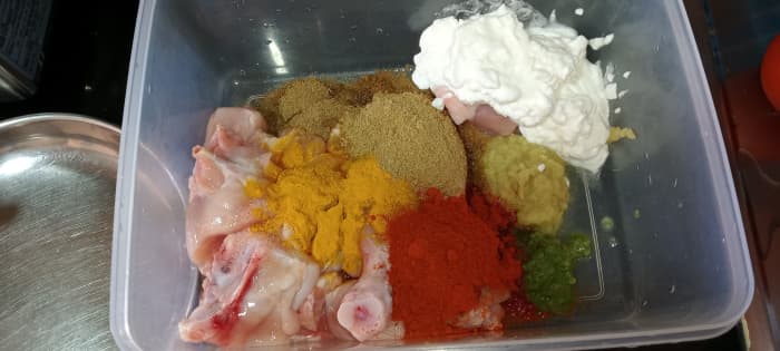 Marinate the chicken with ginger garlic paste, green chilli paste, salt, turmeric powder, red chilli powder, coriander powder, cumin powder & curd.