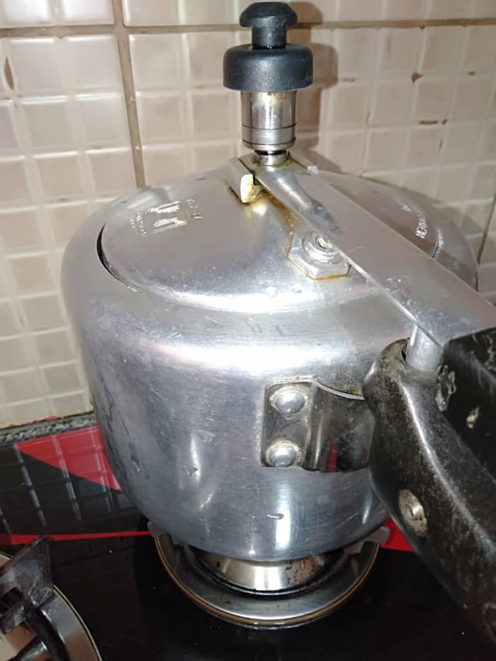 Pressure-cook soaked split pigeon peas to 1 whistle. Lower the flame and cook for 7-8 minutes; then switch off the flame. Let the pressure cooker cool down completely.