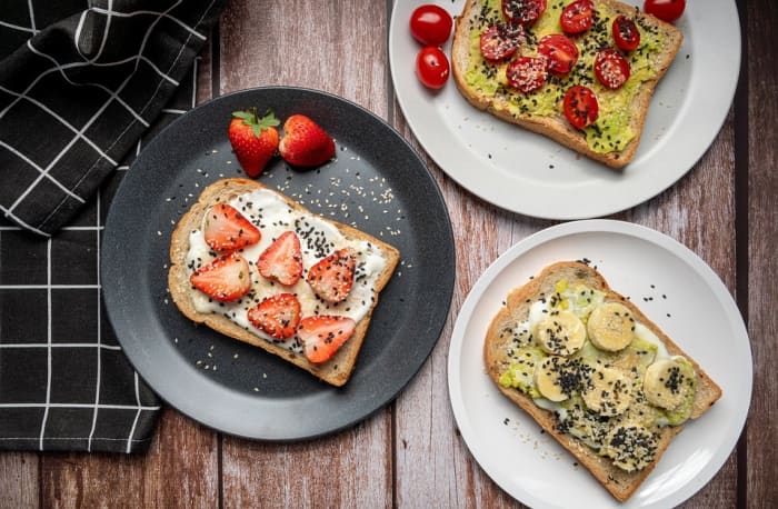 Buttered and loaded toast falls with one half somersault and lands messy side down.