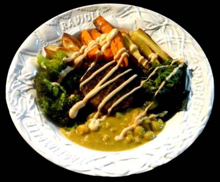 Veggie burger with roasted potato, sweet potato and parsnip, steamed broccoli and spring greens, and curried chick peas with coconut milk. The sauce is Perinaise mild.