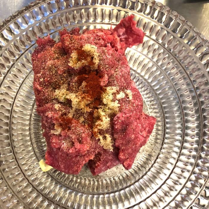 The meat should be bright red. You should see a little fat marbling throughout. If it is brown or grey, it's too old.
