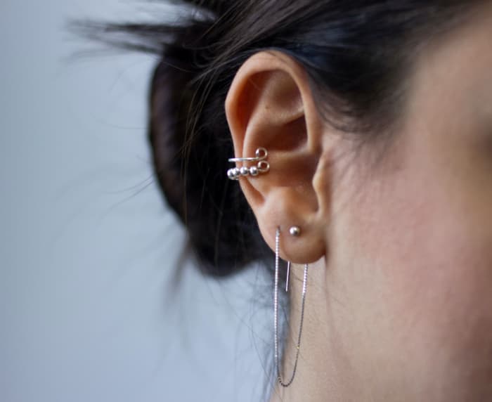 Your piercings should not cause you any pain or soreness. For further advice, consult a qualified medical professional.