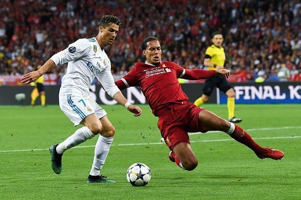 Liverpool Fc's Virgil Van Dijk (right) tackling Real Madrid's Cristiano Ronaldo (Left) during the 2018 Champions League Final.