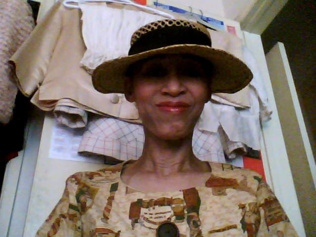 Victoria Moore in a vintage hat and brown print dress from the 1950s.