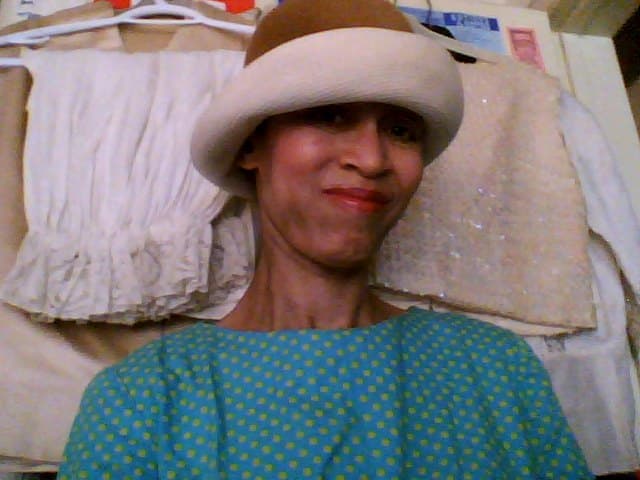 Victoria Moore in a vintage hat and a green polka dotted dress from the 1960s.