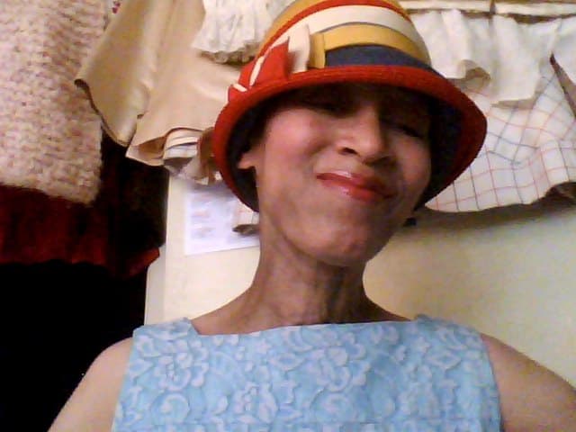 Victoria Moore in a vintage hat and light blue mini dress from the 1960s.