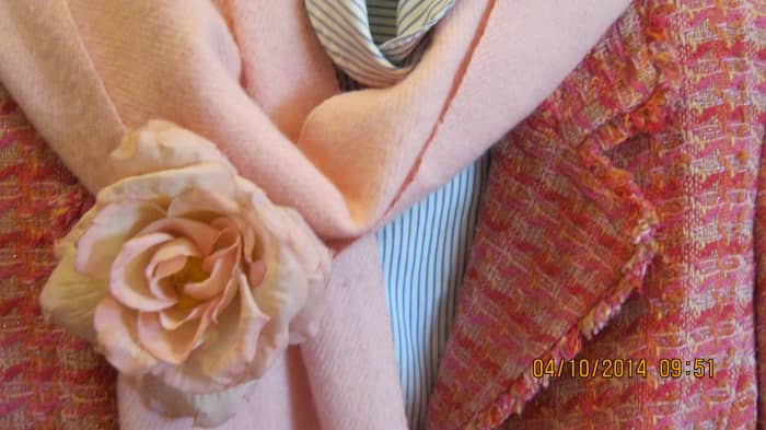 Pink Chanel-esque jacket with striped blouse, pink scarf and pink rose pin.