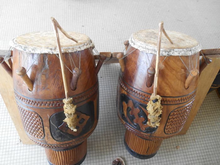 Atumpan drums are placed in pairs, each facing the other, with one producing lower tones and one producing higher ones.