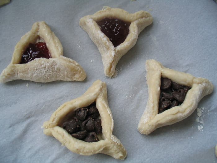 Two jelly and two chocolate chip hamantaschen ready to bake. 350F for 20-25 minutes, until dough is golden brown.