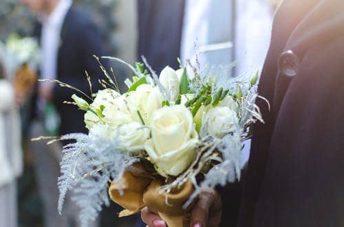 He couldn't give her flowers while she was alive. He could give her flower on her coffin.