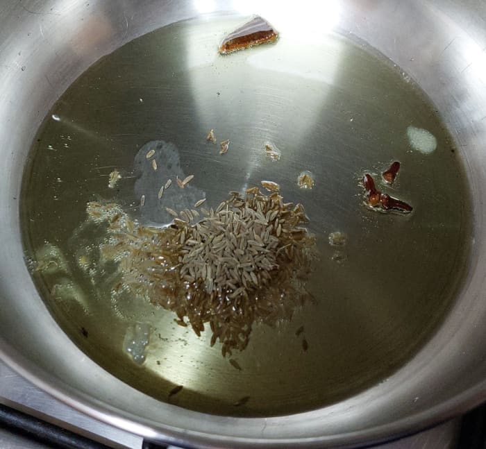 In a pan, heat 1–2 tablespoons oil or ghee and add 1-inch-long cinnamon stick, 2–3 cloves and 1 teaspoon cumin seeds. Let them splutter.