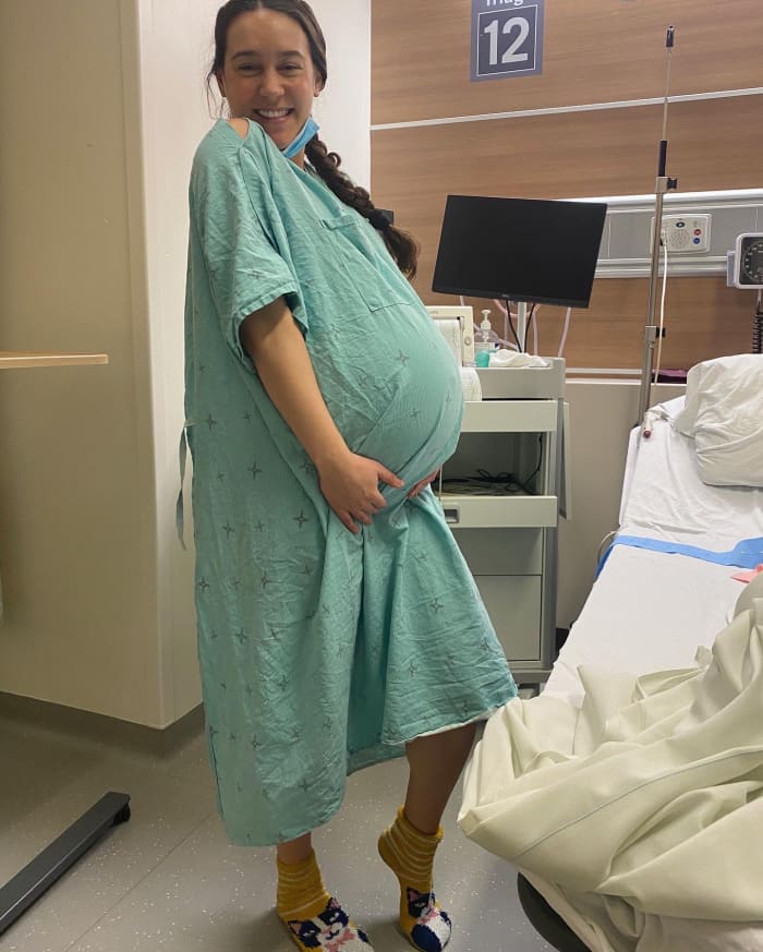 The singer-songwriter looks forward to the birth of her little man in the hospital, wearing cat socks for good luck.