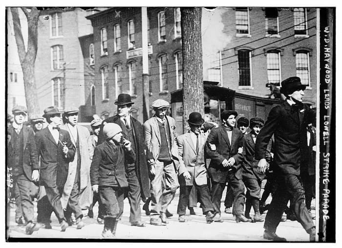 Big Bill Haywood (tall man in bowler hat) leads workers in the 1912 Lowell, Massachusetts textile strike.