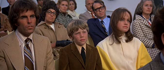 Terry (Ernie F. Orsatti) Robin (Eric Shea) and Susan (Pamela Sue Martin) take in church service on New Year's Eve Day