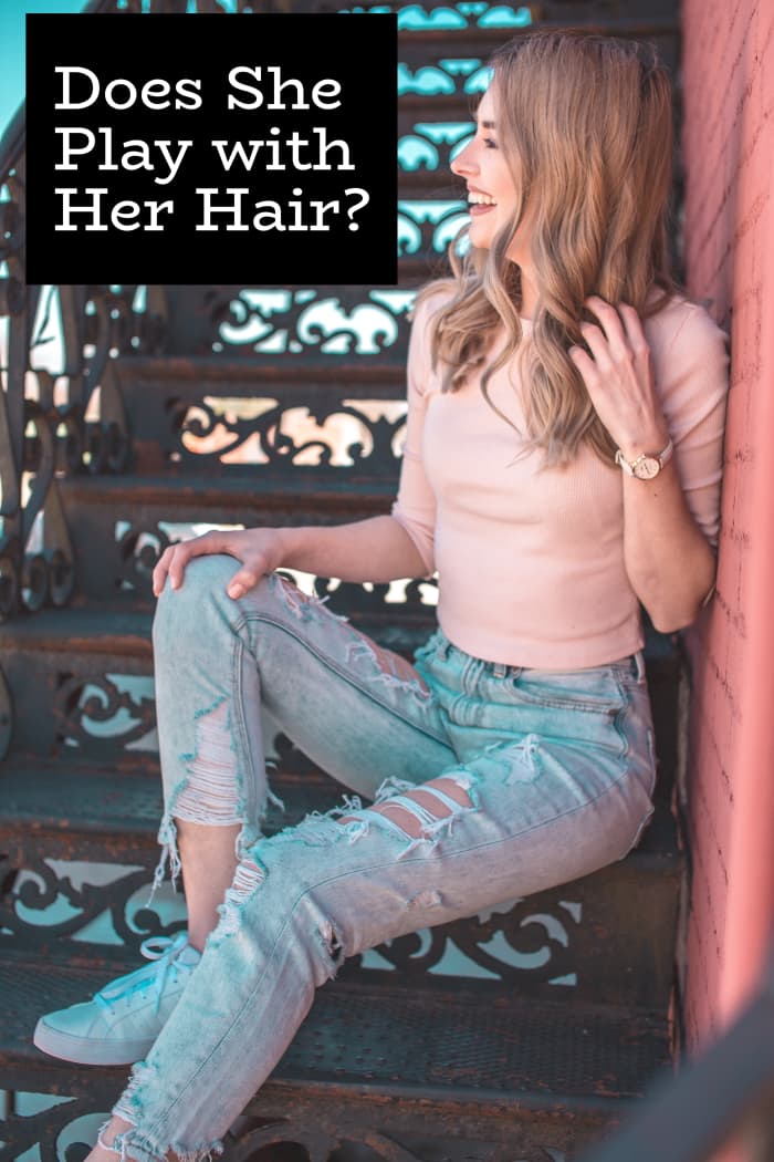 Sometimes when we don't know what to do with our hands because we're nervous, we start playing with our hair. It's also a flirty thing to do.