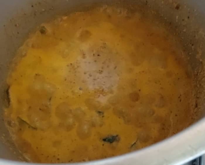 Add ground paste, fry till raw smell of masala disappears. Add little water (about 1/4 cup), close the lid and let it boil for a minute.