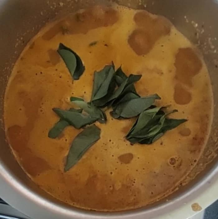 Add 1/4 cup of tamarind extract (or use tamarind paste), and 1 teaspoon of jaggery. Add salt to taste. Add a sprig of curry leaves.