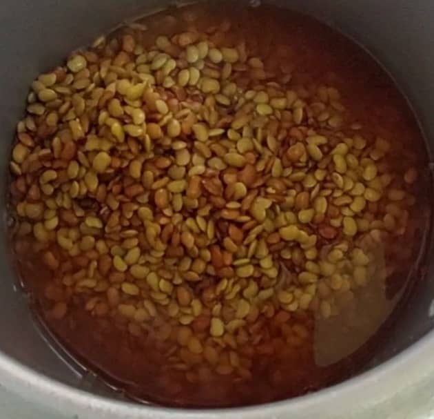 Transfer the soaked horse gram to the cooker (along with soaked water), and add 1/2 teaspoon of salt.