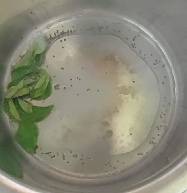 In a vessel or pan, heat 1 tablespoon of cooking oil, splutter 1/2 teaspoon of mustard seeds, add a spring of curry leaves and fry for a few seconds.