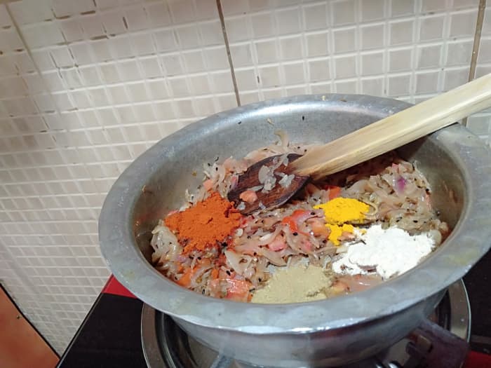 Further, add turmeric powder, red chilli powder, coriander powder and dry mango powder. Give a good mix and cook until oil separates.