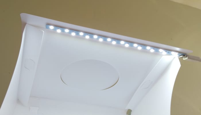 Small Portable photo studios have one or more strips or rings of overhead LED lights.