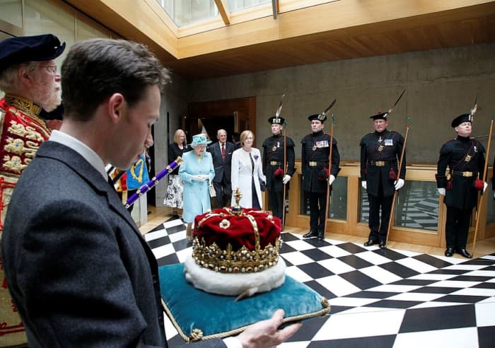 Elizabeth II at the state opening of the Scottish Parliament in 2011. The crown is carried by Alexander Douglas-Hamilton, 16th Duke of Hamilton.