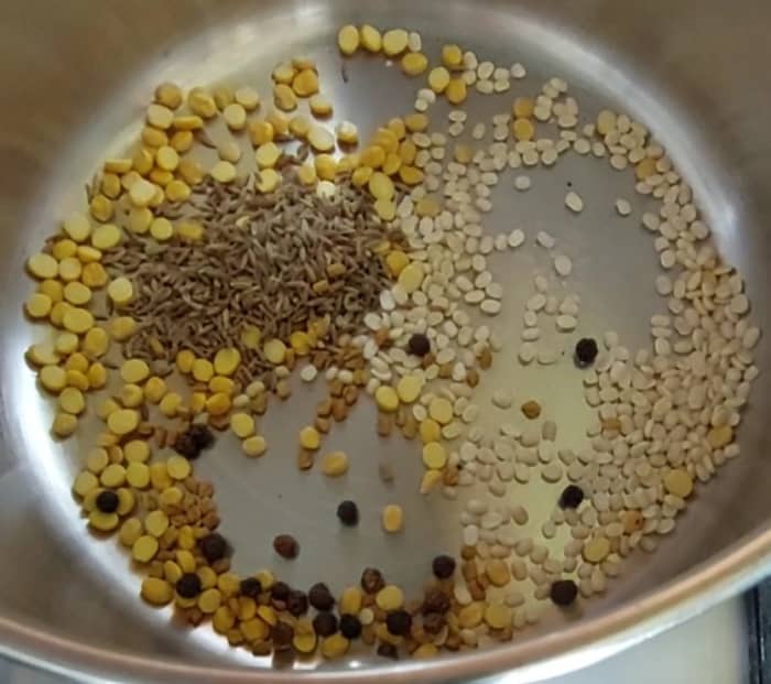 In a pan, add 1 tablespoon chana dal, 1 tablespoon urad dal, 1 teaspoon cumin seeds, 1/2 teaspoon methi seeds, 7-8 peppercorns.