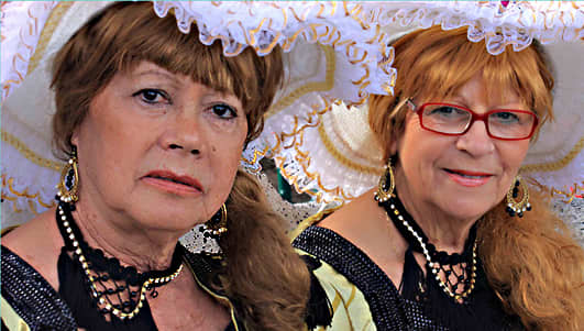Clowning has its place in Carnival, but so does old fashioned grace, as two parade participants sit on a bench and await their turn in the hour before 4.00pm