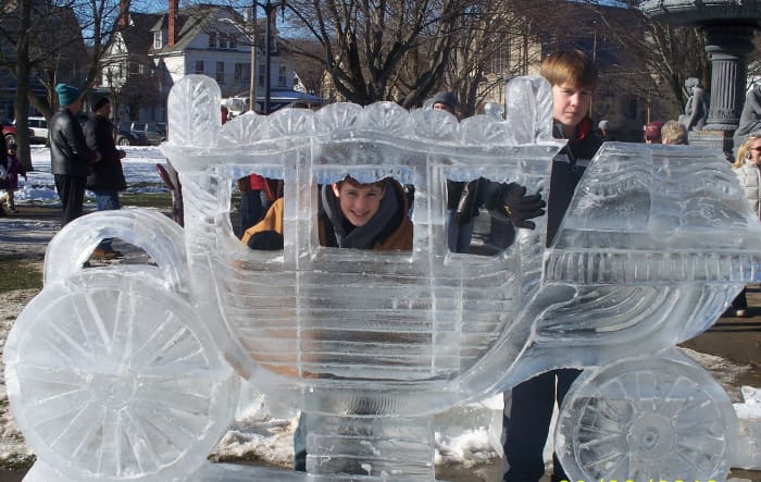 This sculpture, sponsored by Joy Manufacturing, is in honor of Art DiMartino who founded DiMartino Ice in 1968. Art worked for Fisher Body, a division of General Motors for 40 years. The carriage is the Fisher Body logo.