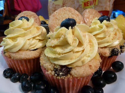 Lemon-almond cupcakes, lemon curd filling, blueberry crumble topping, lemon curd infused buttercream frosting, crushed Iced Lemonade Archway cookies topping.