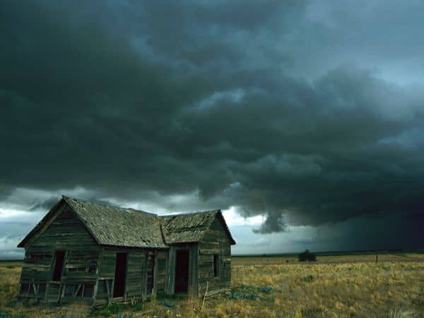 Photograph by Carsten Peter, National Geographic Heavy clouds hang low over a dilapidated homestead in the Midwest, foretelling a possible tornado.