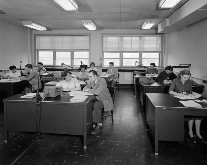 Workers at a NASA office go about their business in the 1950s, a period where working 5–6 days a week was commonplace.