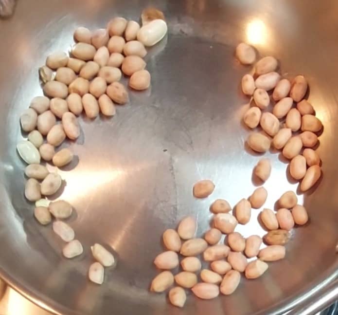 In a pan, dry-fry 3 tablespoons of peanuts till they change color and become aromatic (or until the skins start to separate). Transfer to a plate and set aside.