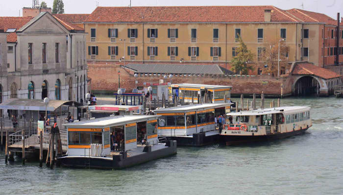 Piazzale Roma vaporatto station as seen from the Ponte di Calatrava (Constitution Bridge). A vaporetto arrives at one of the station platforms for the passengers to board