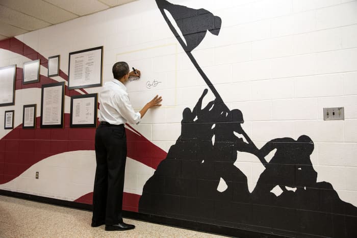 President Barack Obama signs the Wall of Freedom at Mentor High School in Mentor, Ohio, Nov. 3, 2012.