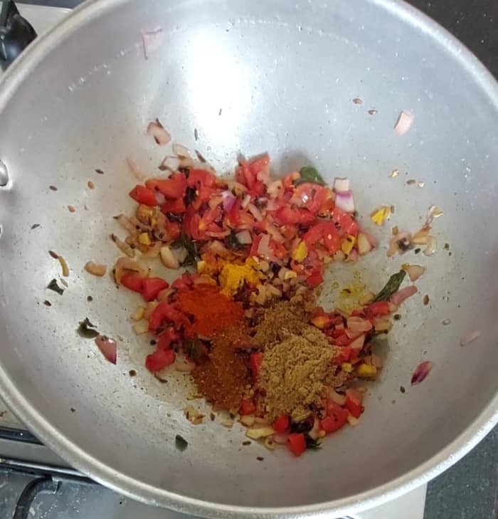 Add 1/2 teaspoon turmeric powder, 1/2 teaspoon cumin powder, 1 teaspoon red chili powder, 1 teaspoon coriander powder and 1/2 teaspoon garam masala powder. Mix well.