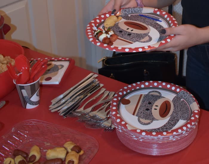 Sock Monkey paper plates, napkins and cups. The colors are red, gray and white. We added some blue too.