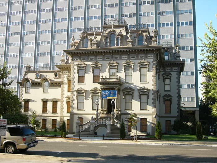 Leland Stanford Mansion and State Park between high-rise buildings, remodeled in 1871 and a National Historic Landmark in Sacramento.