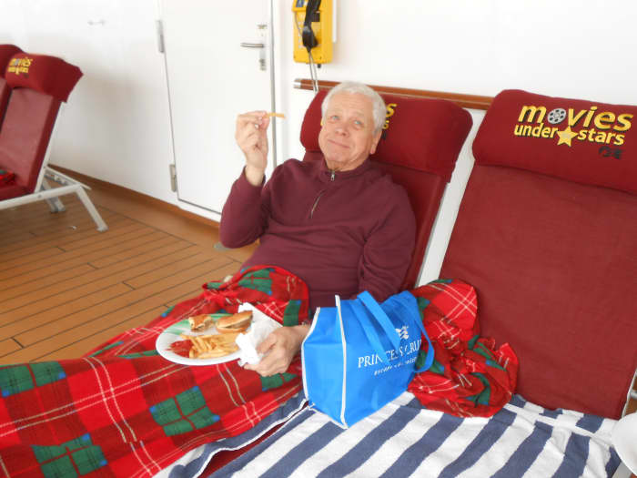 Princess cruise ships have Movies Under the Stars and offer free popcorn and blankets and pillow for snuggling under. Or, have a pizza dinner from the Pizza grille located on the same deck as the movies.