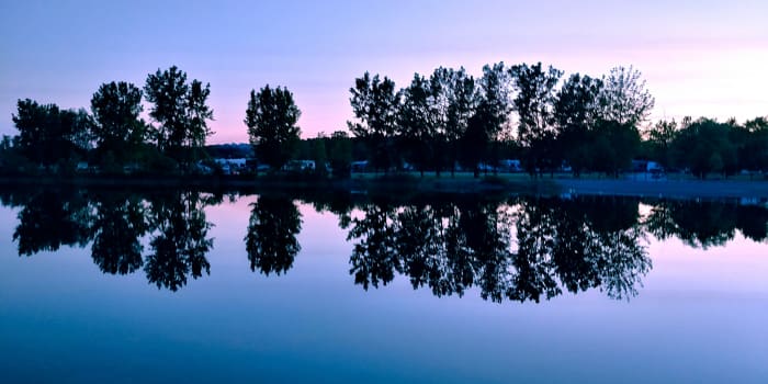 A glorious sunset view of campsites over the main pond at Gravel Ponds in Scottsville, NY. ©2018 BW Duerr