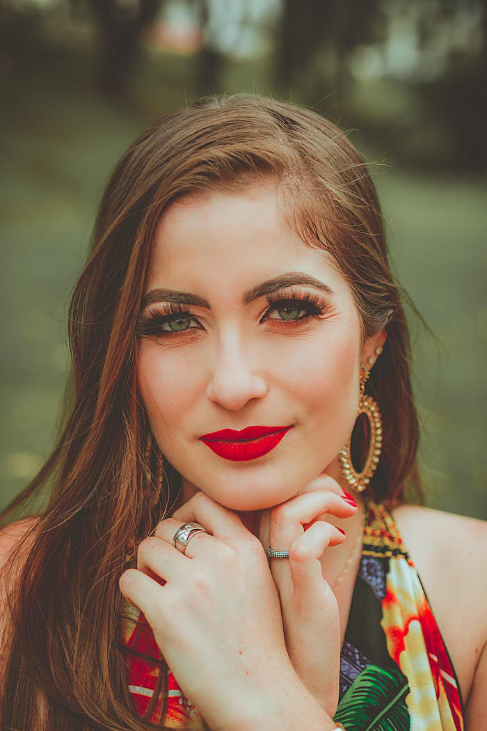 Aries can amplify their look with more intentionally with their hair and a splash of red lipstick. Get bold with: patterns, red eye shadow, and gold earring hoops.