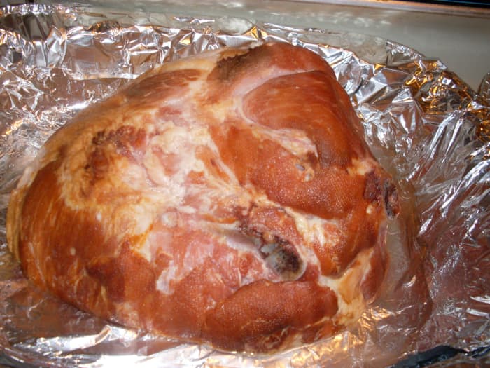 HOW TO MAKE GLAZED HAM RECIPE : cured ham halfway through the cooking process. Place your ham with 1 cup of water in a deep pan lined with foil to cook at 350 degrees.