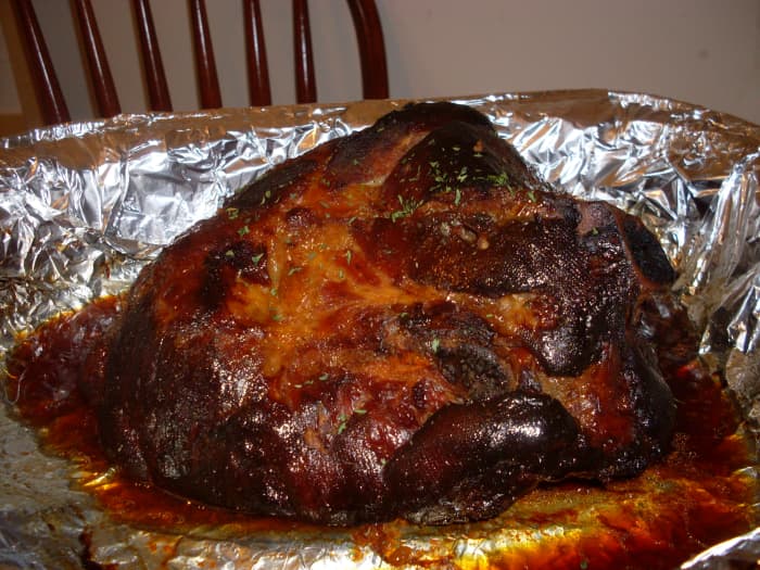 After 3 hours of cooking time. Cover the ham with foil throughout the cooking process if you would prefer that it not have a very dark (burnt/ seared top) appearance as in these photos