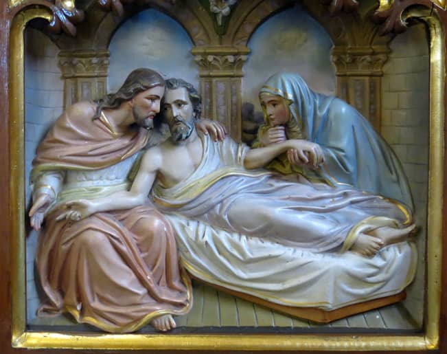 Mary and Jesus assist St. Joseph in his death. St. Joseph is the patron saint of the dying. Woodcarving from Holy Trinity Church, Indianapolis, Indiana