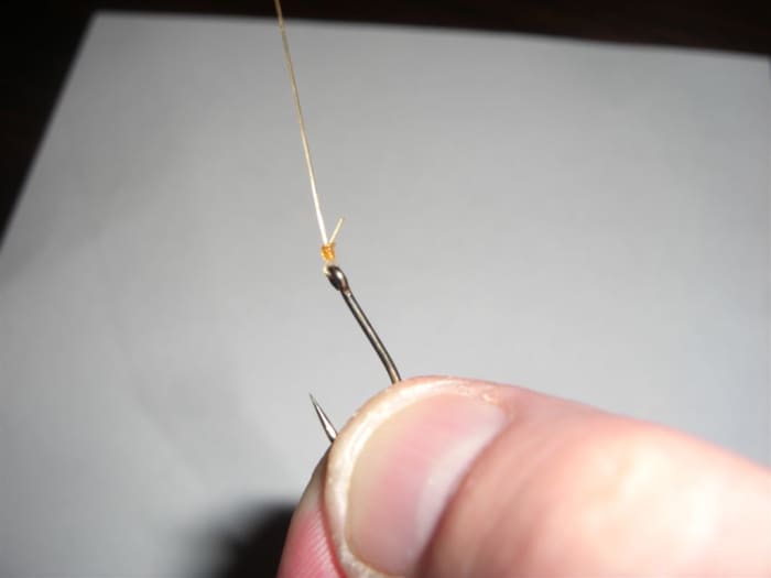 Step 11, trim the free end of the line back until it is very close to the knot without a risk of the knot slipping.